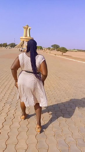 Playful Outdoor Dance Moves by a Woman in Polka Dots