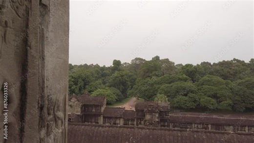 Absara sculpture on the wall in Angkor Wat, and the jungle view