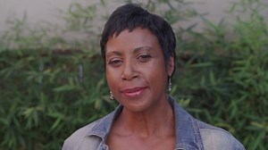 clip-1095632371-portrait-beautiful-older-woman-standing-outside-front