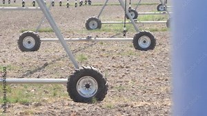 Sprinklers On Center Pivot Irrigation System Watering Field. Slow Motion