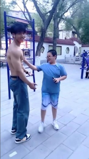 boy touching bodybuilder's muscles