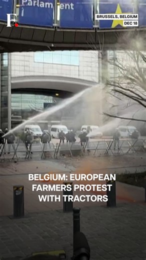 Firstpost on Instagram: "#FPReels| Belgium: Farmers Storm Brussels Streets With Tractors and Smoke Bombs European farmers staged a fiery protest in Brussels on December 18, as EU leaders met on trade and agriculture. Tractors rolled into the city, horns blaring, while protesters hurled smoke bombs and objects at police. Officers later used high-pressure water cannons to disperse the crowds. Farmers say years of crisis, trade deals like Mercosur, and possible budget cuts threaten their livelihood