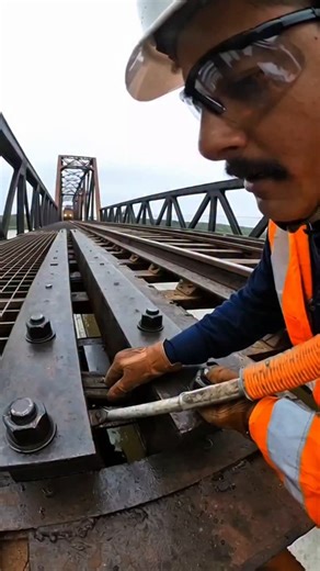 CHAMP VISION on Instagram: "RAILWAY BRIDGE MAINTENANCE 🚆⚙️ Active train line. Violent vibration. Precision work above open exposure. [ ai vlogs, ai content, extreme jobs, railway bridge, high risk work, vibration, pov video ] #aicontent #viralshorts #fyp #reels"