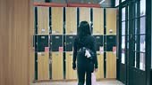 Asian woman entering the gym locker room
