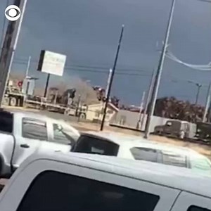 TRAIN CRASH: Video shows a train hitting a semi-truck stuck on the railroad tracks in Texas Tuesday. The driver was able to escape the vehicle in time and call 911. https://cbsn.ws/2SVatg7 | CBS News