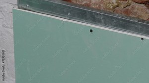 Repairer Make Install Drywall using Screwdriver and Screw, close