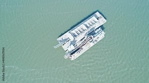 Sand extraction in the middle of a great lake. Sandpit and lake dredging, specialized machine, water barge, boat.