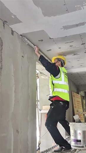 manual smoothing of wall cement layers using a putty knife for a very neat and also clean results