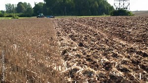 Tractor discing stubble field. Agricultural machine cultivating farm land soil