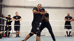 Tian Bing tightens a headlock on Kenneth Crawford