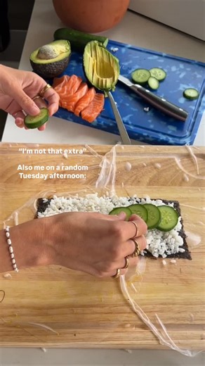 giant crispy rice paper sushi 🍣 🍱🥑 Lightly soak 4 rice paper wrappers, place them on a board (slightly overlap each). Add your fillings - nori, sushi rice, salmon sashimi (place on straight after rice to keep it raw or if you want it slightly seared like I did, place it on the outer layer before the nori), avo, cucumber, kewpie mayo, another layer of nori. Roll it all up - coat in some black and white sesame seeds. Heat some oil in a frypan over medium to high heat. Cook the giant roll until 