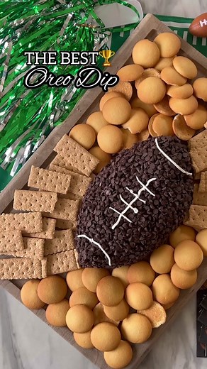 Oreo Football Dip! 🏈🏆 I’ve made this for Super Bowl the last 3 years, and it’s always a 10/10!!! Super easy to make, but be warned, it’s addicting! 😋 Ingredients: 18 Double Stuf Oreos 8 oz cream cheese 1 stick butter 2 tablespoons chocolate syrup 2 cups powdered sugar Package mini chocolate chips White frosting Directions: 1. Crush the Oreos in a food processor until fine. Throw into a big bowl. 2. Add in cream cheese and butter. Beat until smooth. 3. Add in chocolate syrup and powdered sugar