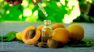 Apricot kernel essential oil in a bottle. Selective focus.