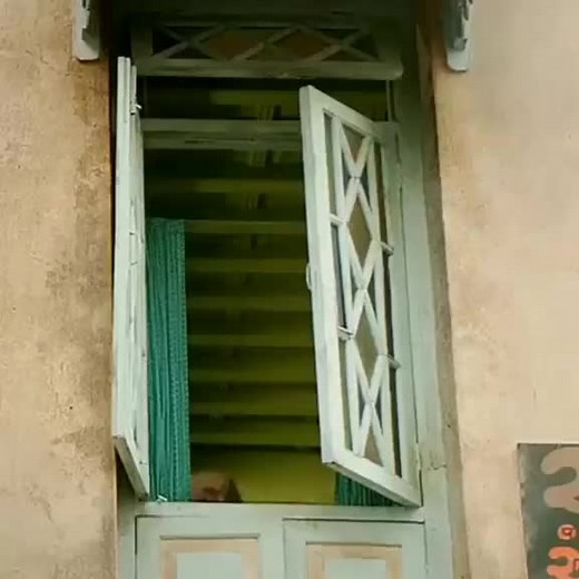 Man Interacting at a Rustic Building Window