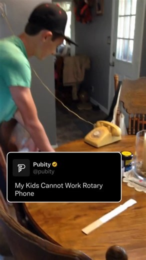 Pubity on Instagram: "☎️🤔👧🇺🇸 Kids stare at a rotary phone in total confusion, poking at it and trying every method except the right one. They guess, they twist, they lift it up and shake it like a toy, all while their parents laugh quietly in the background. It is a perfect mix of nostalgia and humor. In America, technology changes so fast that even the simplest old devices feel like mysteries to kids today, and watching them figure it out never gets old. (VIA: @VIRALHOG)"