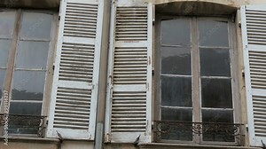 Old style big windows of the cafe building. The windows have big opening and small fence on the veranda