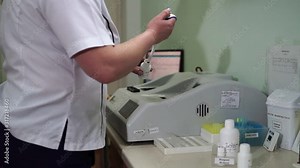 A female lab assistant is preparing blood tests. Modern medical technology. Mtdicinal lab.