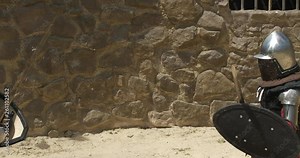 Aggressive brutal Fight of two knights Fencing with swords Strike to the head with weapons