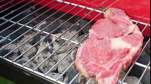 Raw red meat on the grill in 4k