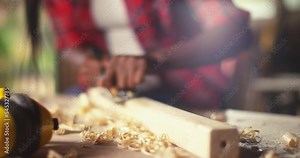 An African American carpenters are using spoke shave to decorate the woodwork.