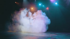 Ballet. Graceful ballerina dancing elements of classical ballet in the beautiful light and smoke on the background, High quality 4K footage.