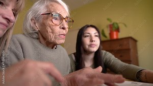 Family Tech Time: Senior Woman Learning Computer Skills with Loved Ones.