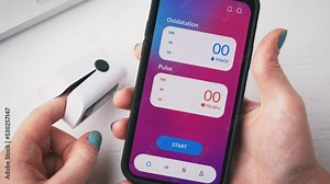 Woman checks oxygen saturation on his smartphone. Pulse oximeter app for mobile phone.