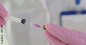 Nurse drawing medicine into syringe from ampoule in clinic closeup 4k movie slow motion. Intravenous and intramuscular administration of drugs concept