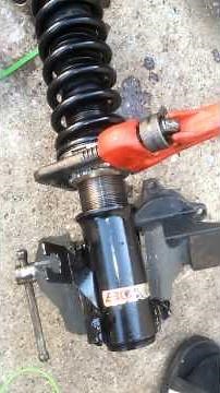 Adjusting a rusted coilover.
