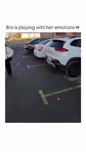 YOUR VIBES ✌🏻 on Instagram: "This video shows a playful interaction between a person holding the camera (presumably a man, based on the hand) and a young woman. The scene takes place outdoors in what appears to be a parking lot or street on a sunny day. The video begins with the woman walking toward the camera, wearing a light-colored, puffy jacket and dark pants. The person filming playfully attempts to hold her hand. The woman initially pulls away, using her hands to cover her ears as if in p