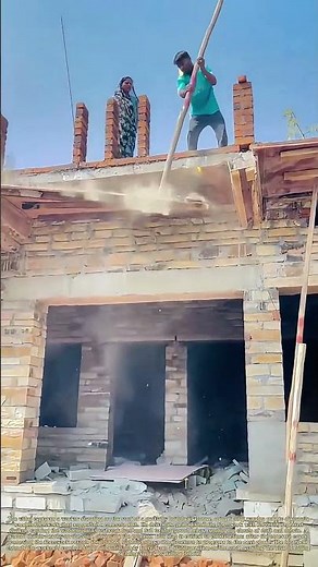 Breaking the Mold: How a Worker Uses a Long Pole to Dismantle Roof Formwork