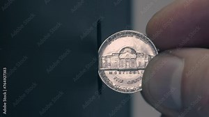 Male fingers inserting a five cent coin into a coin receiver, the light is brightly reflected from the surface of the coin. Closeup. Macro. Slow mo, slo mo, slow motion, high speed camera, 240fps, 250