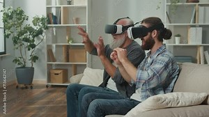 Young man and elderly male play VR games, using virtual reality headsets and controllers, intergenerational communication through technology, family entertainment, teaching older generations new games