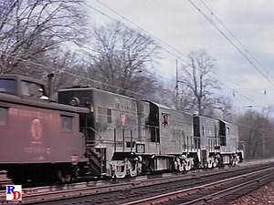 A shot of an electric powered Pennsy freight, with a pair of Baldwin RT624 centercabs pushing. Then it just keeps getting better! We're guessing this is at Wynnewood on the Harrisburg Line. From the Railroad Video Productions show "Pennsylvania Power, Volume 7" https://rfd.video/PRRPower7 | Railfan Depot