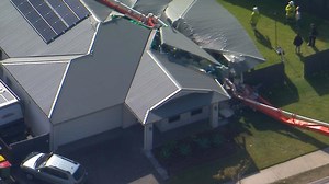 Concrete pumping truck topples onto Ipswich house