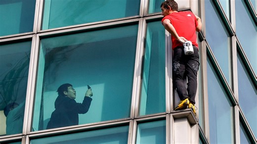 Moment rock climber reaches top of 101-story tower in Taiwan without ropes