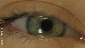 Extreme close up human eye iris in 4K UHD video. Human eye iris contracting. Extreme close up. 4K UHD 2160p footage.