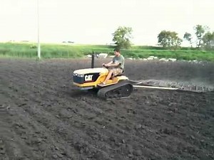 Mini CAT Challenger pulling 4 harrows