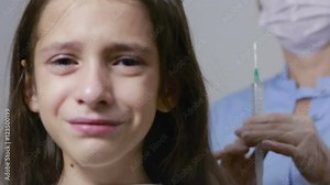 little girl is afraid of the doctor with a syringe. baby cries afraid injection Stock Video