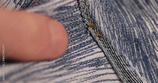 old blue repaired jeans after they are torn, patching with a lot of threads after repairing jeans