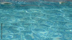 Swimming pool water at summer day. Blue water rippled in a swimming pool, 4k