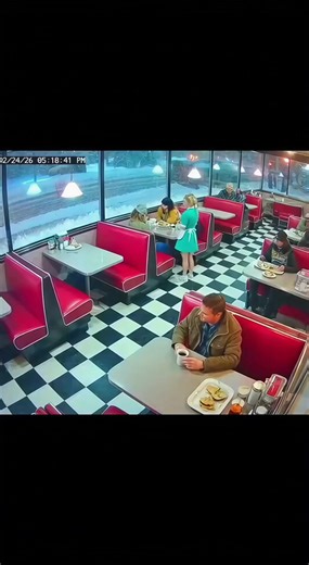Cctv Footage Of A Massive Elk Crashing Through A Retro Diner Window During A Snowstorm ------------ ----------- ------------- This dramatic security footage captures a shocking moment inside a peaceful retro diner. The scene begins with a classic mid century atmosphere, featuring vibrant red vinyl booths, checkered flooring, and a waitress tending to duties near a cake display. Outside, a thick snow covers the ground, visible through the large plate glass windows that line the front of the build