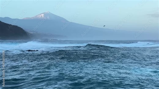 Atlantic ocean waves with Teide volcano mountain in Tenerife Canary Islands Spain scenic coastal seascape