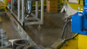 Real shot assembly line inside automated robotic assembly machine of motor coil in a factory production process automobile manufacturing plant