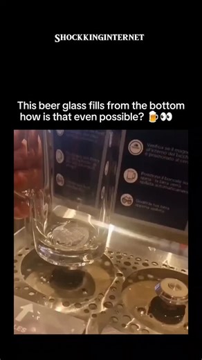 Shockkinverse on Instagram: "This fascinating beer glass uses a bottom-filling system known as the Bottoms Up Beer Dispenser. Unlike traditional pouring methods, this technology fills the glass from the base using a magnetized valve and a specially designed hole. When the glass is placed on the dispenser, a magnetic ring at the bottom lifts, allowing beer to flow in from below. Once filled, the magnet seals the hole shut, preventing leaks. This method is not just cool to watch—it’s fast, efficie