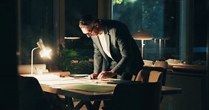 Man, night and success with blueprint in office, fist pump and vision achievement with infrastructure. Celebrate, architect and edit document with floor plan for layout efficiency, goals and pride