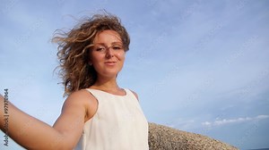 Beautiful Young Woman at Bright Beach in Summer Sun.