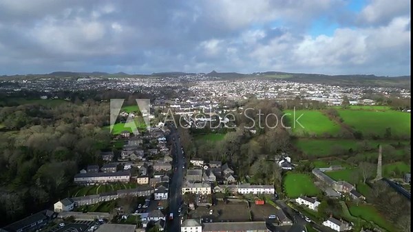 Charlestown, Cornwall, England: DRONE VIEWS: The drone flies over Charlestown harbour towards St Austell; China clay spoil heaps can be seen on the horizon. St Austell is a former clay mining town.