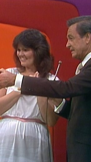 Bob Barker has fun with a Price Is Right contestant on stage. | The Price Is Right: The Barker Era