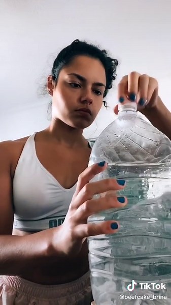 Girl Chugging 5 Gallons of Water: A Gymrat's Daily Challenge